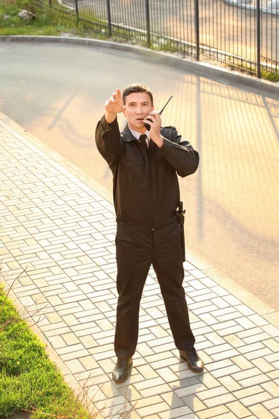 Protetor de segurança masculino com rádio portátil, ao ar livre — Fotografia de Stock