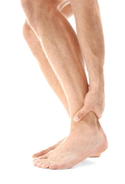 Young man suffering from pain in leg — Stock Photo, Image