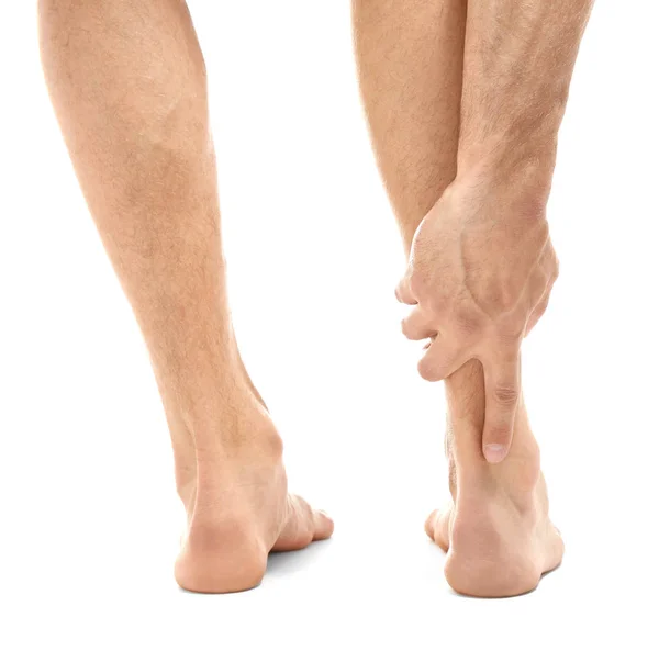 Young man suffering from pain in leg — Stock Photo, Image