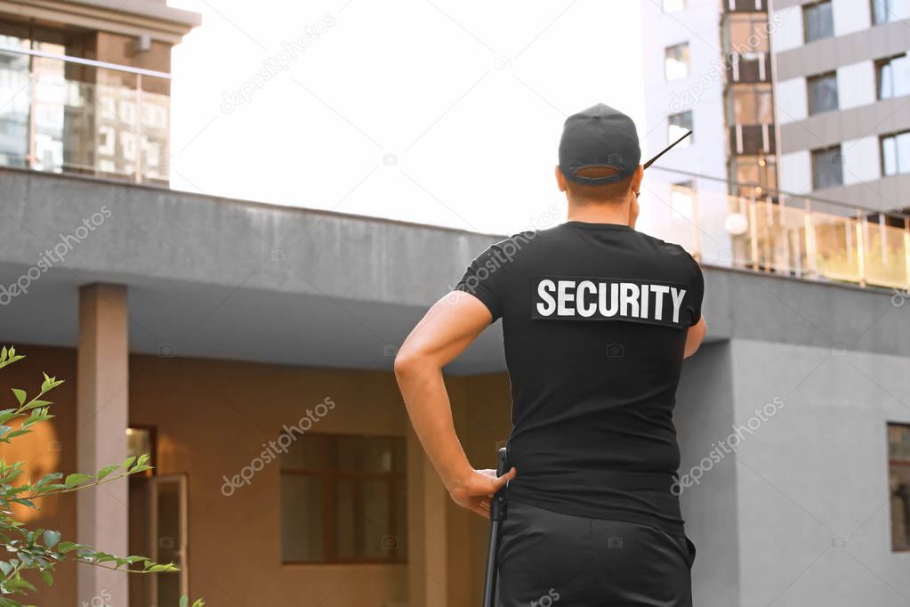 Male security guard with portable radio