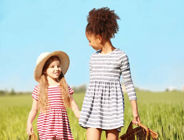 Happy little girls in green field — Stock Photo, Image