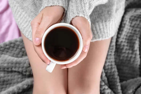 Young woman on bed with cup of coffee — Stock Photo, Image