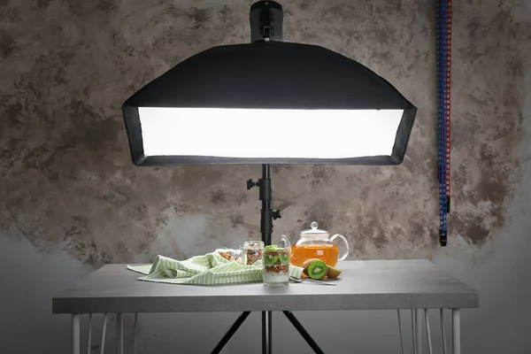 Samenstelling met voedsel op tafel in moderne fotostudio — Stockfoto
