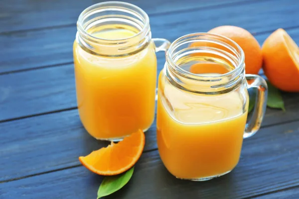 Mason jars with fresh orange juice — Stock Photo, Image