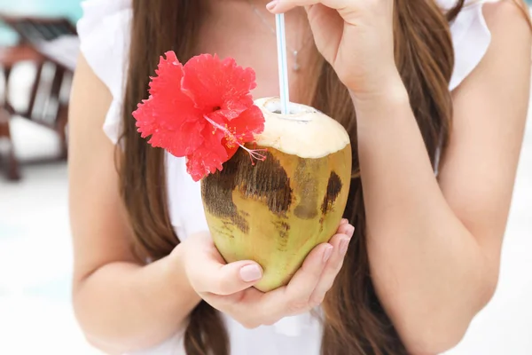 Young woman with fresh coconut cocktail at resort, closeup — Stock Photo, Image