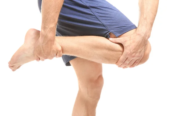 Young man suffering from pain in leg — Stock Photo, Image