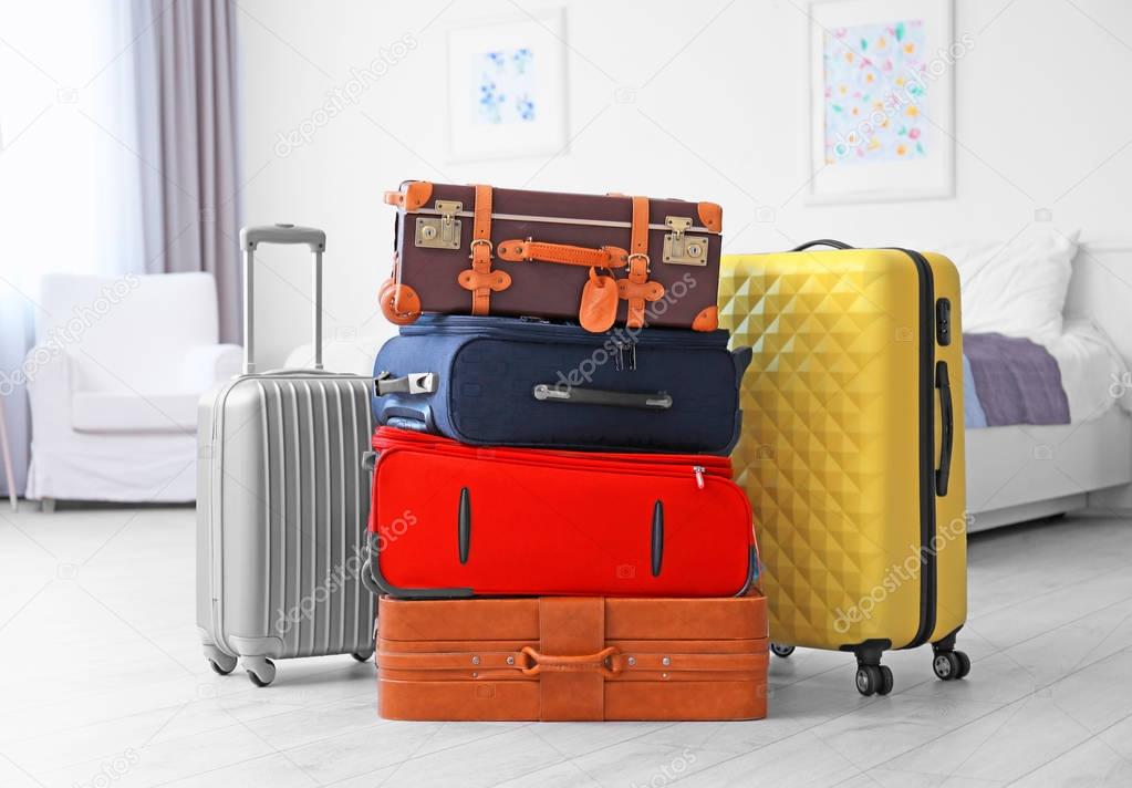 Different suitcases in light room. Luggage overweight concept