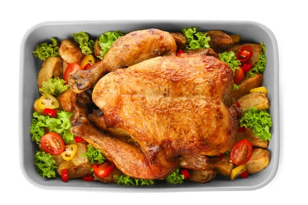 Baking dish with roasted turkey and vegetables on white background