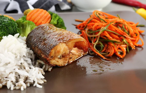 Plate with delicious fish, sauce, rice and vegetables — Stock Photo, Image