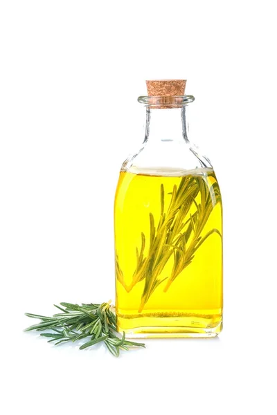 Láhev s olejem rozmarýnu a byliny — Stock fotografie