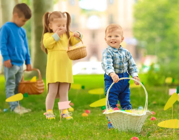 Children having fun in park. Easter egg hunt concept — Stock Photo, Image