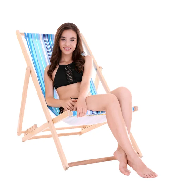 Young woman sitting on deck chair — Stock Photo, Image