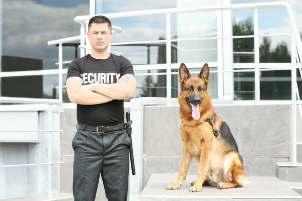 Security guard with dog near building — Stock Photo, Image