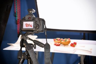 Gıda çekerken tripod üzerinde profesyonel fotoğraf makinesi
