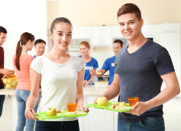 Happy teens holding trays with food indoors — Stock Photo, Image
