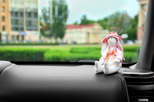 Чарівна іграшка на приладовій панелі автомобіля. Подорожі з концепцією маленької дитини — стокове фото