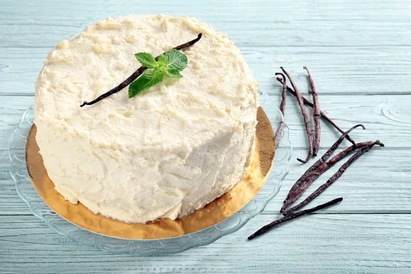 Delicious vanilla cake on wooden table — Stock Photo, Image