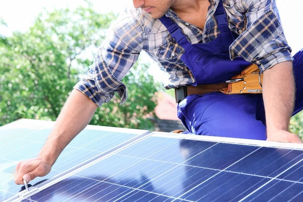 Trabajador instalando paneles solares al aire libre — Foto de Stock