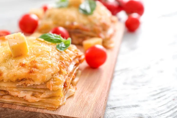 Tasty lasagna on wooden board — Stock Photo, Image