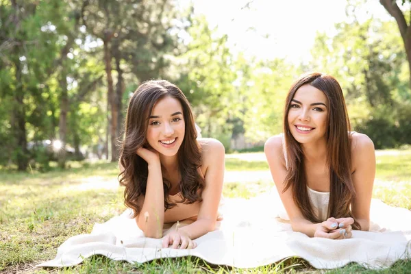 Mujeres jóvenes tomando el sol en el parque —  Fotos de Stock