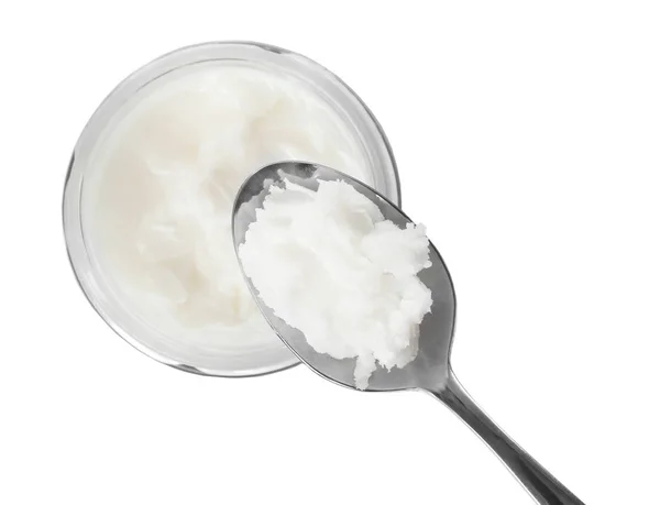 Spoon with coconut oil and jar on white background — Stock Photo, Image