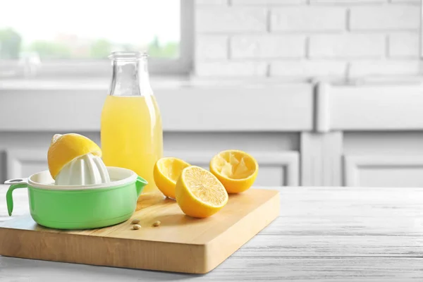 Composition with lemon squeezer on table in kitchen — Stock Photo, Image