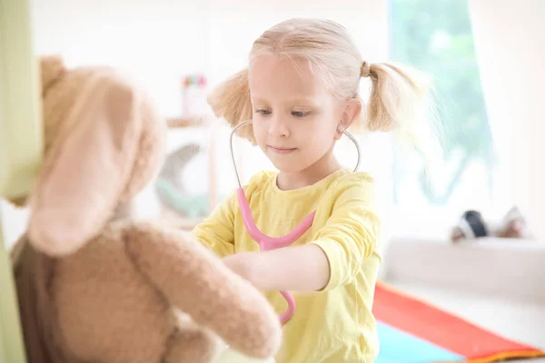 バニーと聴診器を自宅で遊ぶ少女 — ストック写真