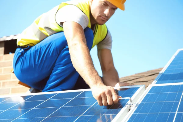 Worker installing solar panels outdoors Stock Image