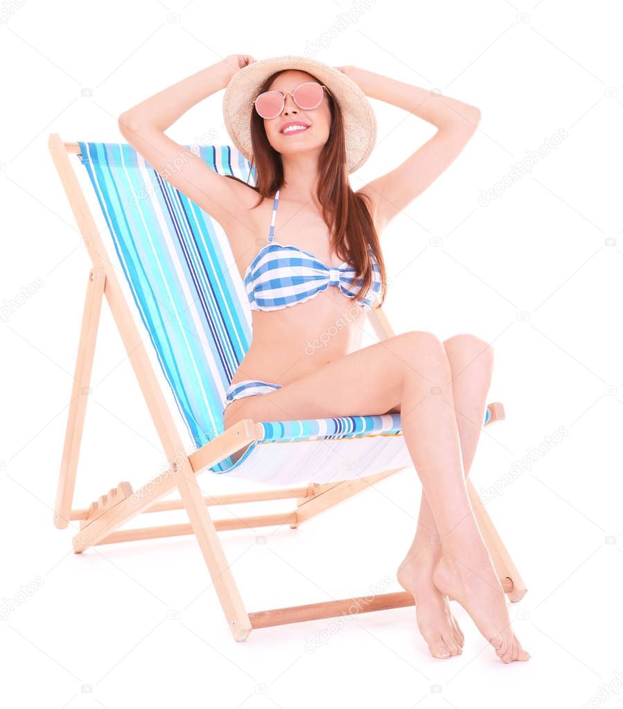 Beautiful young woman on deck chair