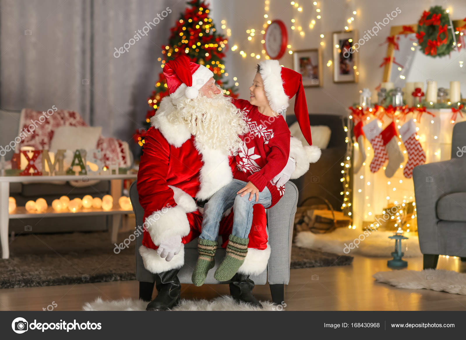Happy Little Boy Sitting On Santa S Lap In Room With
