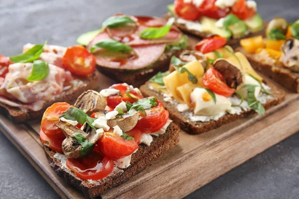 Ahşap tahta üzerinde lezzetli ev yapımı sandviçler ile kompozisyon