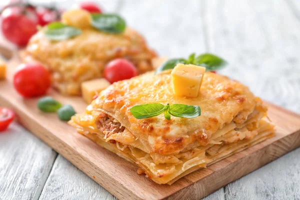 Tasty lasagna on wooden board — Stock Photo, Image