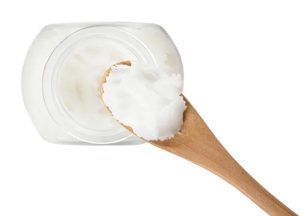 Löffel mit Kokosöl und Glas auf weißem Hintergrund — Stockfoto