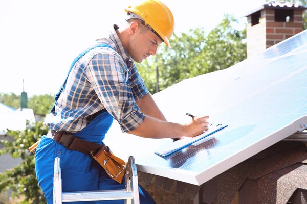 Werknemer installeert zonnepanelen buiten Rechtenvrije Stockfoto's