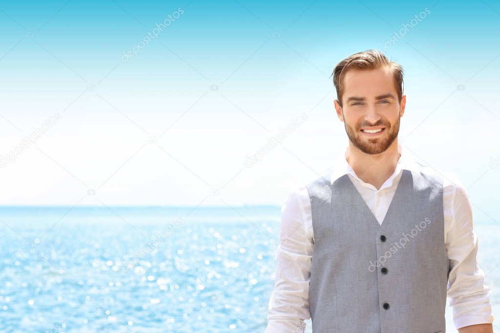 man in costume on seashore