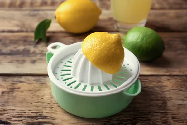 Lemon squeezer on wooden background — Stock Photo, Image
