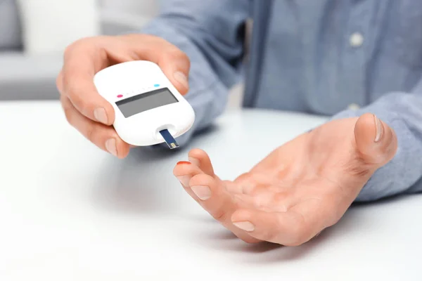 Man using digital glucometer indoors. Diabetes concept — Stock Photo, Image