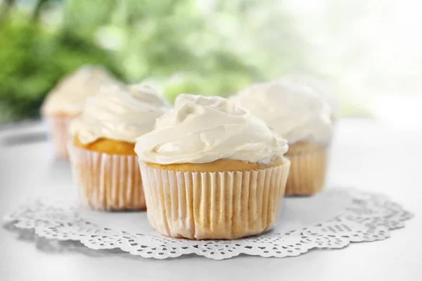 Tasty vanilla cupcakes on table — Stock Photo, Image