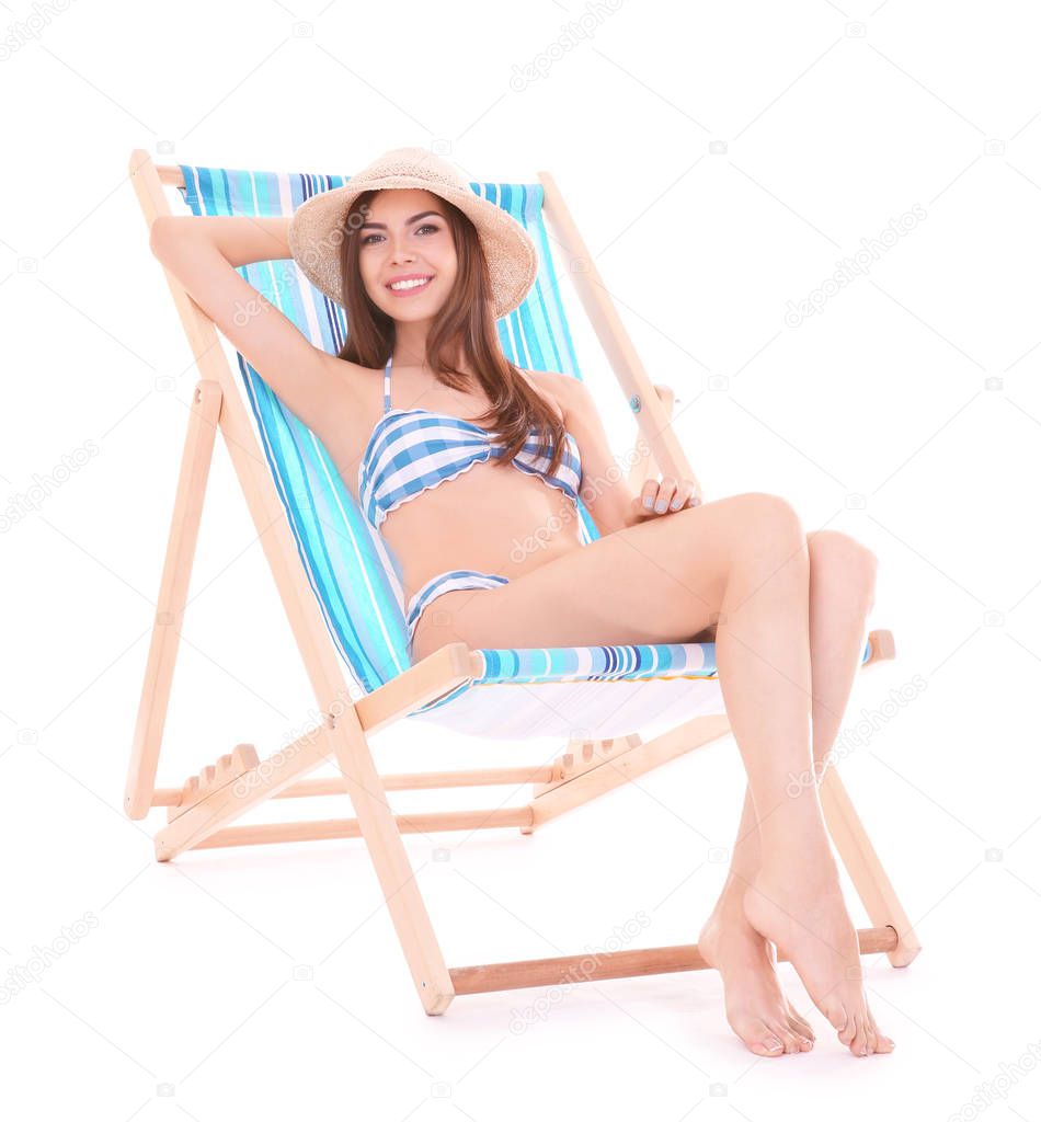 Beautiful young woman on deck chair