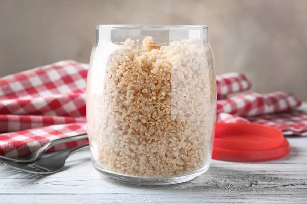 Cooked quinoa in glass jars — Stock Photo, Image