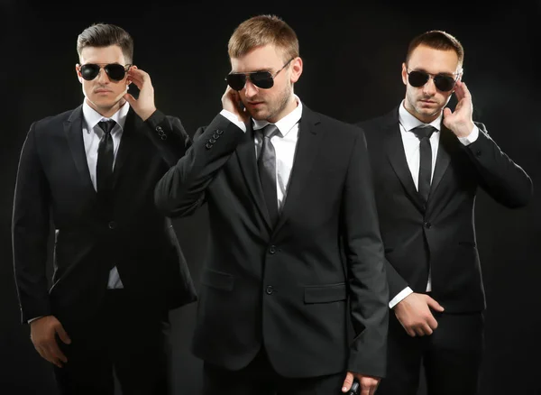 Handsome bodyguards on dark — Stock Photo, Image