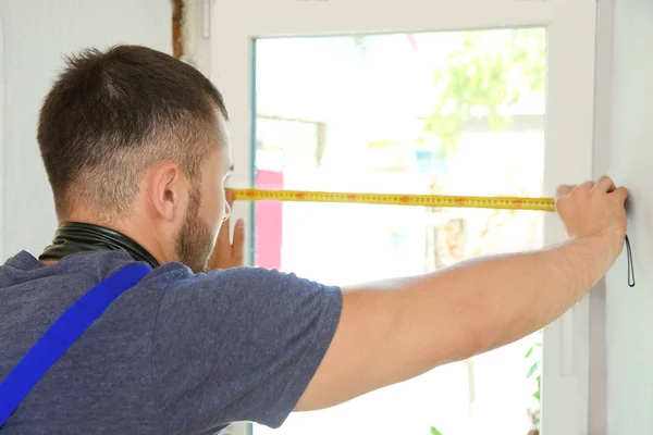 Worker repairing window in flat — Stock Photo, Image
