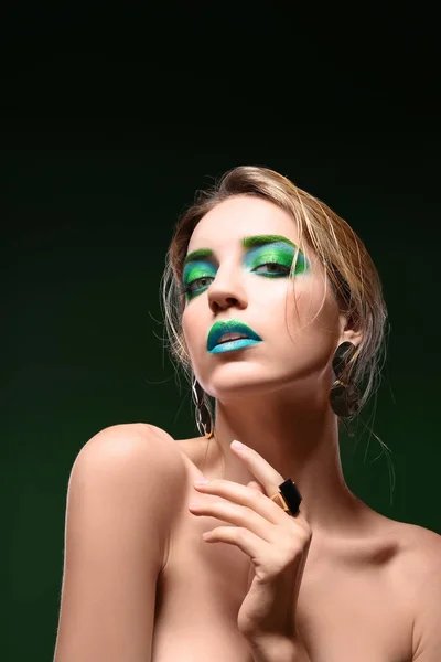 Ung kvinde med lyse grønne makeup - Stock-foto