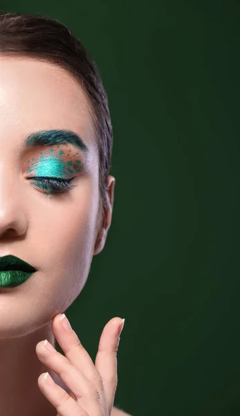 Young woman with creative makeup on color background — Stock Photo, Image