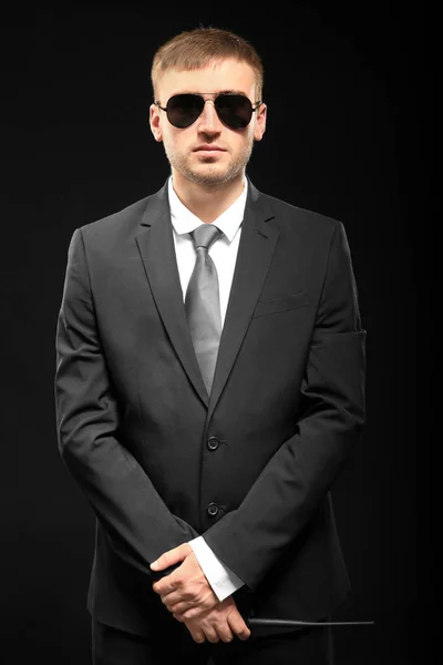 Handsome security guard on dark background — Stock Photo, Image