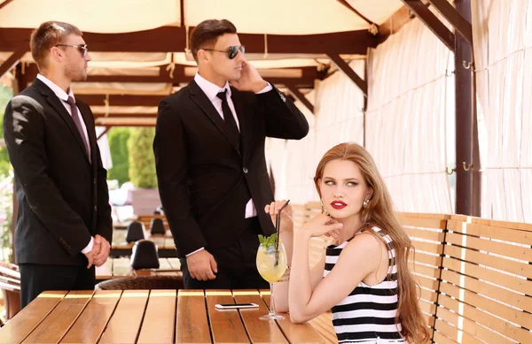 Young businesswoman with bodyguards — Stock Photo, Image