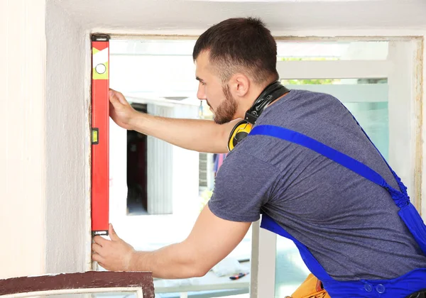 Worker repairing window in flat — Stock Photo, Image