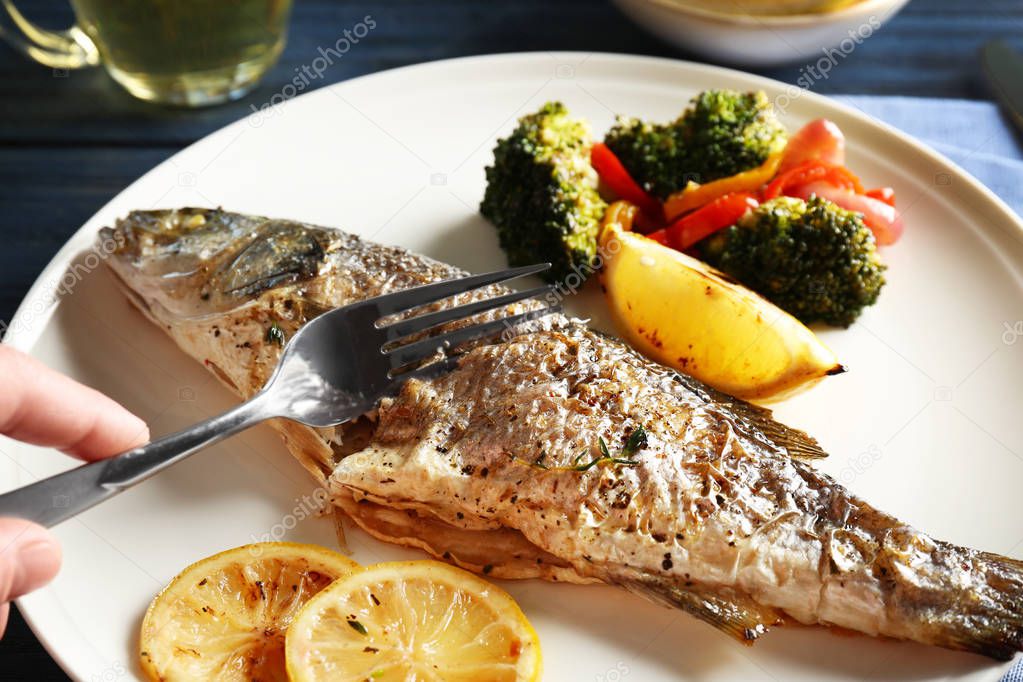 Woman eating baked fish