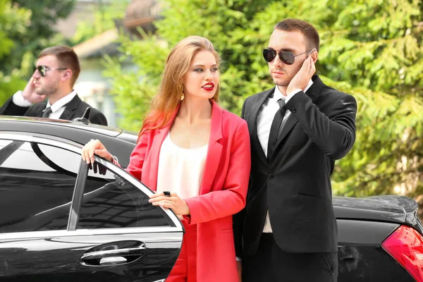 Young businesswoman with bodyguards — Stock Photo, Image