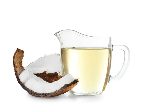 Ripe coconut and pitcher with oil — Stock Photo, Image